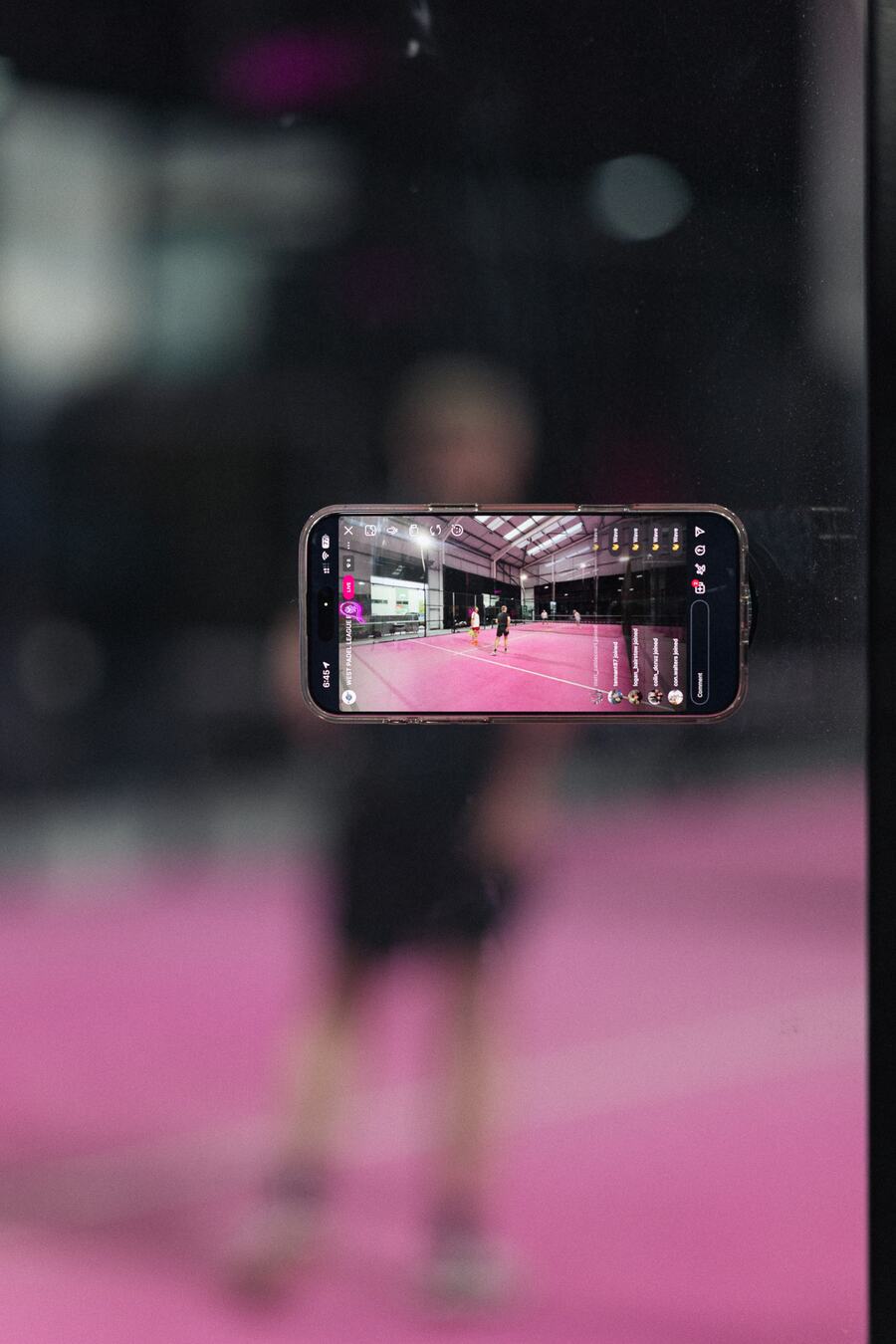 A phone fixed to the glass, live-streaming the final on Instagram.
