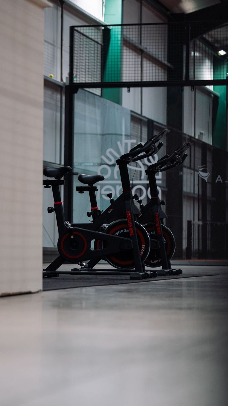 Exercise bikes in the warm-up gym behind a glass wall
